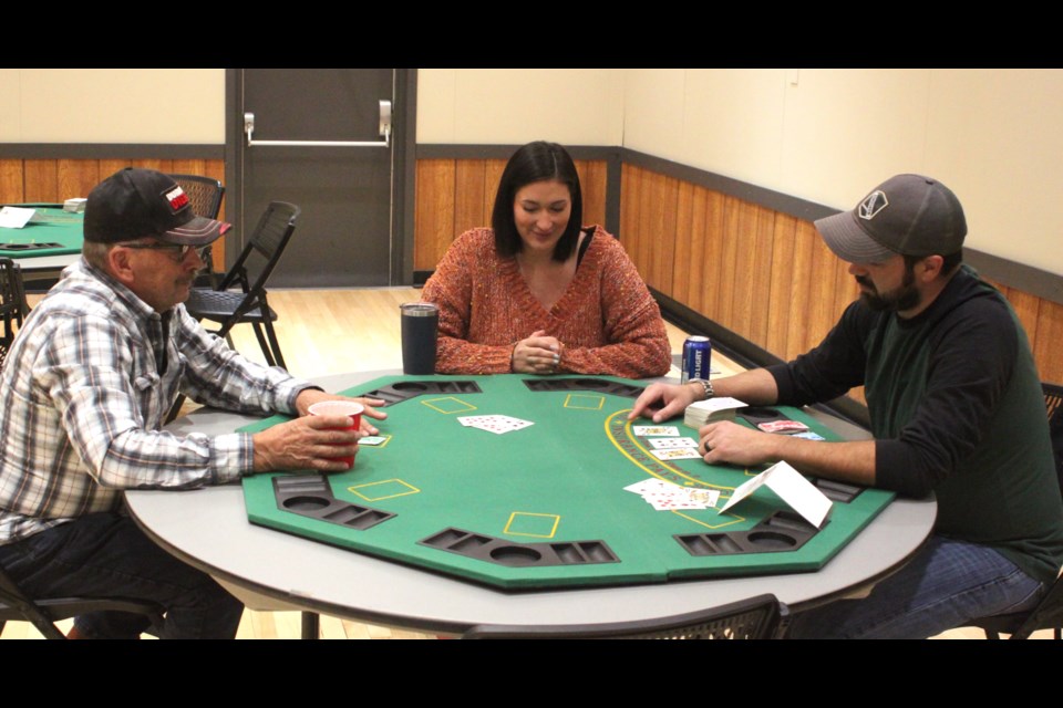 Ron Beniuk, Ashley Buehler and Jason Elkins participate in a game of blackjack at the fun casino night, which took place on March 14 at the Craigend Community Hall. Chris McGarry photo.
