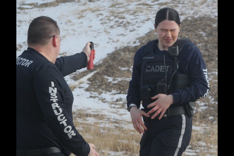 Cadet Montana Thompson, a member of peace officer class #5, reacts after being pepper sprayed by Superintendent Chris Clark, director of the Law Enforcement Training program for Lac La Biche County. The exercise took place on Monday, March 25 at the facility in Lac La Biche. 16 cadets learned how to arrest suspects while being affected by pepper (OS) spray. Chris McGarry photo.