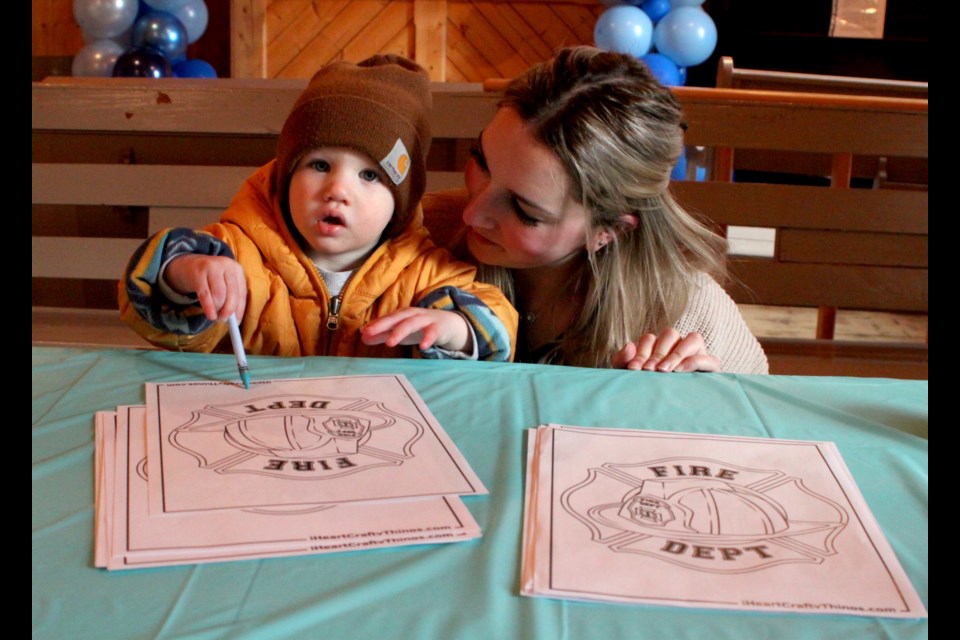Colby Rach, aged 18 months, got in some colouring with his mother, Brooklyn, inside of the Chapelle. Chris McGarry photo. 