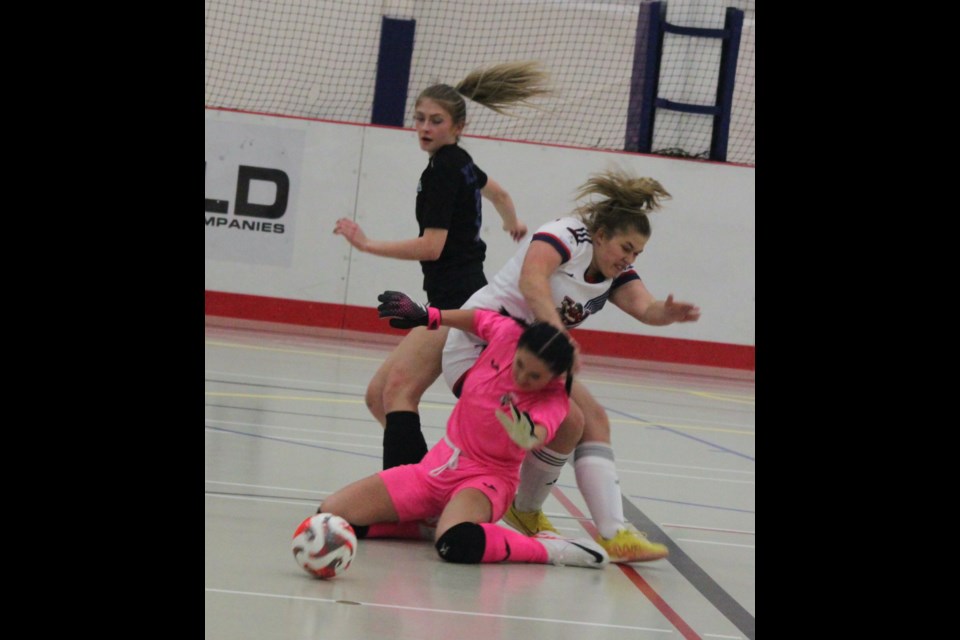 Portage College goalkeeper  Frosia Ambanoudis collides with teammate Emma Bendera and a TKU Eagles player during Friday’s game which resulted in a 7-0 loss for the Voyageurs. Chris McGarry photo.
