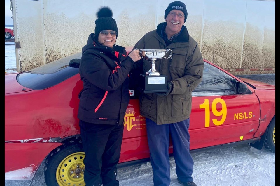 Crystal Anderson won a trophy during her first race in the Danita Malo Memorial Tournament in 2022. She is with Ken Staples, event coordinator for the Winter Festival of Speed, which was recently renamed the Lac La Biche Ice Festival of Speed. Submitted photo.