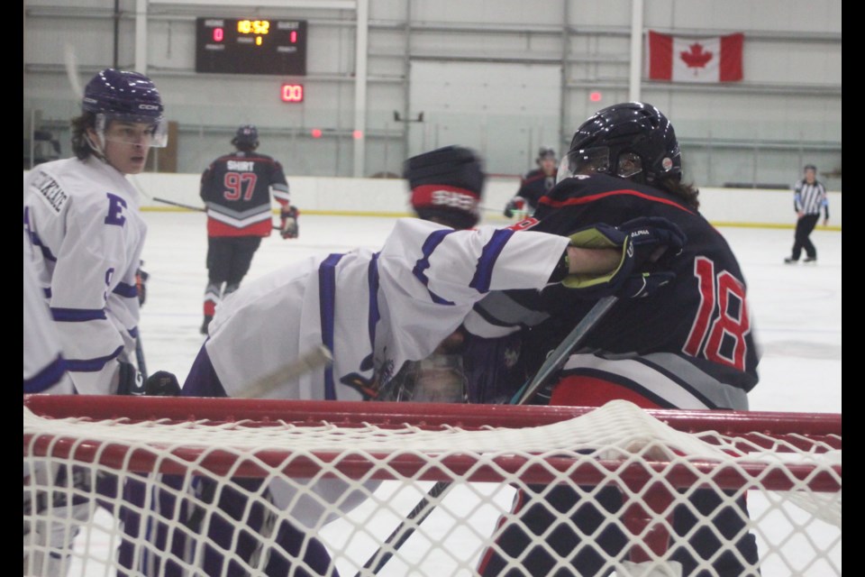 Lakers defenseman Dahlen Ford dukes it out with Ryan Schnider in front of the Edson Eagles’ net during the first period of the Feb. 23 meeting between the two NJHL teams. Chris McGarry photo. 