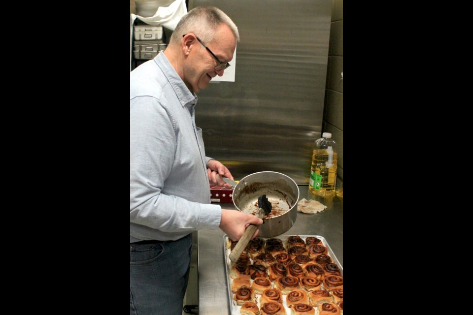 Dale Quist was busy in the kitchen of the Bold Centre Community Hall Monday morning getting over 500 cinnamon buns ready for the Family Day event. Chris McGarry photo.