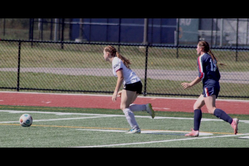 Voyageurs player Dani Funk chases after Assiniboine College Cougar’s Megan Beswitheric to get the ball during the first period of the meeting between the two teams that took place early on the afternoon of Aug. 17 at the Bold Centre sports fields. Funk scored five goals, while teammate Brooklyn MacGillivray got one to give the Voyageurs a 6-0 victory over Assiniboine College. Chris McGarry photo.