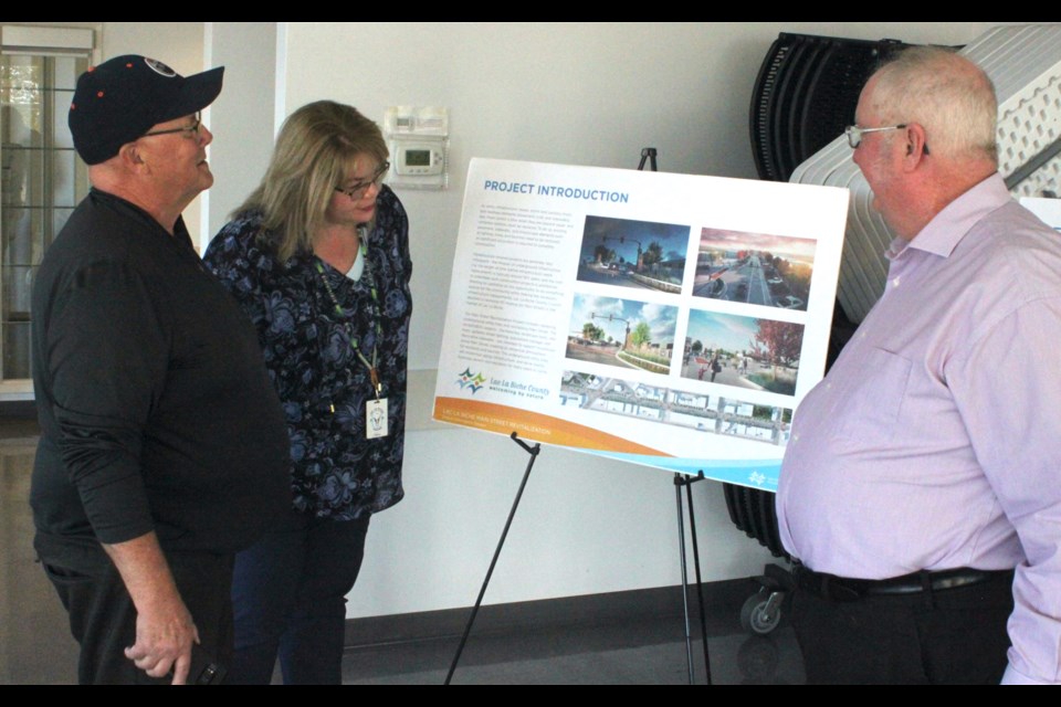 Dave Phillips, president of the Lac La Biche Chamber of Commerce, looks over part of the design plans for the Main Street Revitalization Project with Heather Stromquist, manager of Economic Development and Tourism for Lac La Biche County, and Ron Fraser, Associate CAO of Infrastructure at the open house which took place Wednesday at McArthur Place. Chris McGarry photo. 

Dave Phillips, president of the Lac La Biche Chamber of Commerce, looks over part of the design plans for the Main Street Revitalization Project with Heather Stromquist, manager of Economic Development and Tourism for Lac La Biche County, and Ron Fraser, Associate CAO of Infrastructure at the open house which took place Wednesday at McArthur Place. Chris McGarry photo. 





