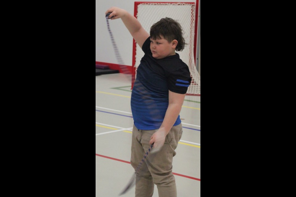 Dax Quintal practices using a flow rope. In gymnastics, flow ropes are used for training shoulders and back as well as enhancing the vestibular system of the body. Chris McGarry photo.