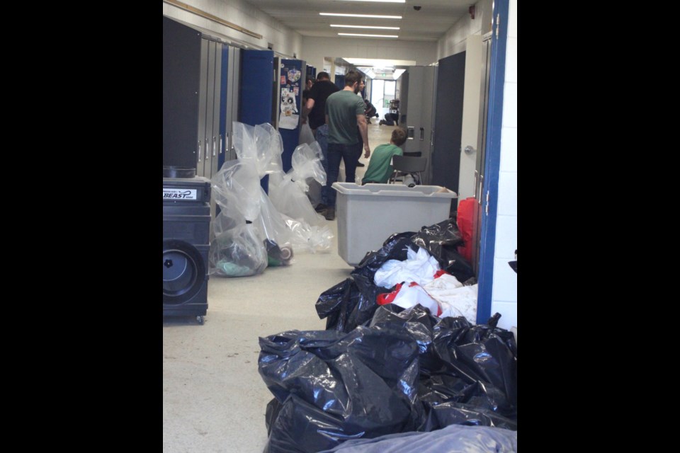 Crews were busy on Tuesday cleaning up the damage caused by the flooding that occurred at the school on Thursday, April 18. Chris McGarry photo. 
