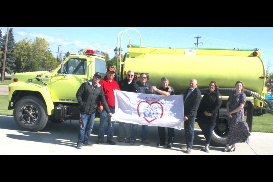 On Sept. 14, Lac La Biche County Fire Rescue Service donated a 1991 Ford water tender to the Heart Lake First Nation fire department. In photo, from left to right; Coun. Garrett Monias, Heart Lake First Nation, Deputy Chief Darren Quintal, Heart Lake First Nation Fire Department, Lac La Biche County Coun. Kevin Pare, Fire Chief Curtis Monias, Heart Lake First Nation Fire Department, John Kokotilo, Regional Fire Chief, Lac La Biche County, Lac La Biche County Coun. Charlyn Moore, Lac La Biche County Coun. Sterling Johnson, and Melanie McConnell, acting CAO of Lac La Biche County. / Chris McGarry photo