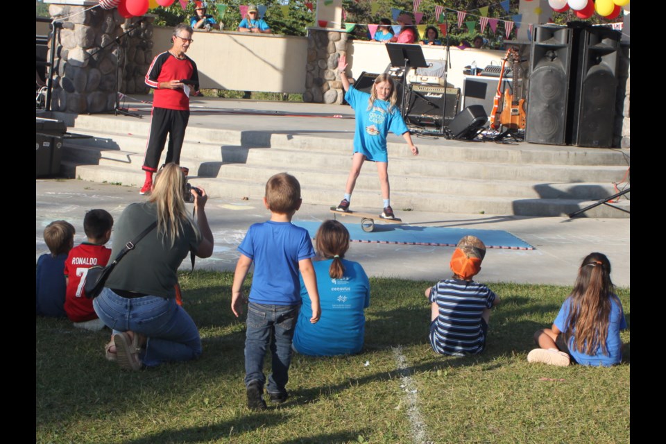 Bob Palmer, a.k.a. ‘Flyin’ Bob’, watches as one of the youngsters who attended his circus camp demonstrates a rola bola during the 2025 Carnival in the Park event held at Lac La Biche’s McArthur Park on Aug. 12. Chris McGarry photo.