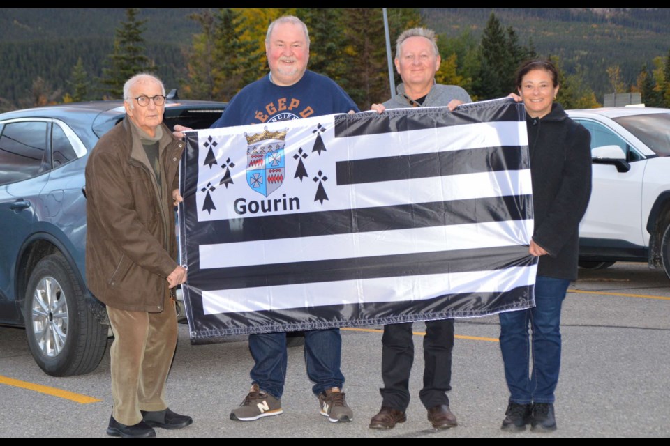 Marcel Carmard, Jean-François Baudet, Pierre-Marie Quesseveur and Valérie Quesseveur, members of the Bretagne Transamerica delegation, holding a flag from Gourin, in the French region of Brittany which was presented to the group of Lac La Biche residents with ancestral ties to Britain and France. The event was held on Sept. 29 and 30 in Gourin, Alberta, a community that once existed between Atmore and Plamondon. Photo supplied. 