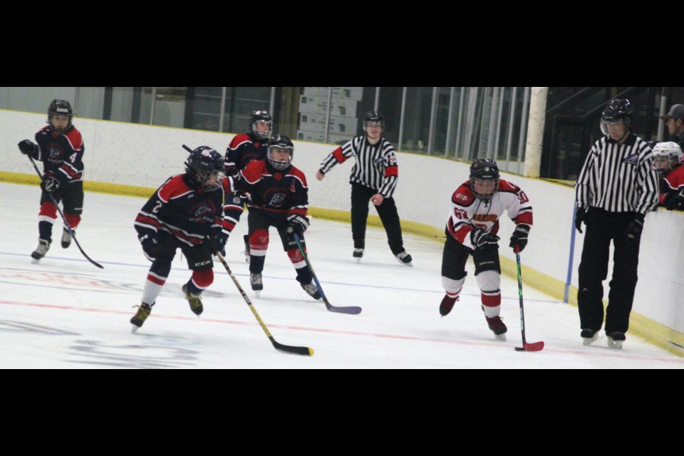 A group of Clippers players race after Keaton Jackson of the Saddle Lake Warriors. Chris McGarry photo. 