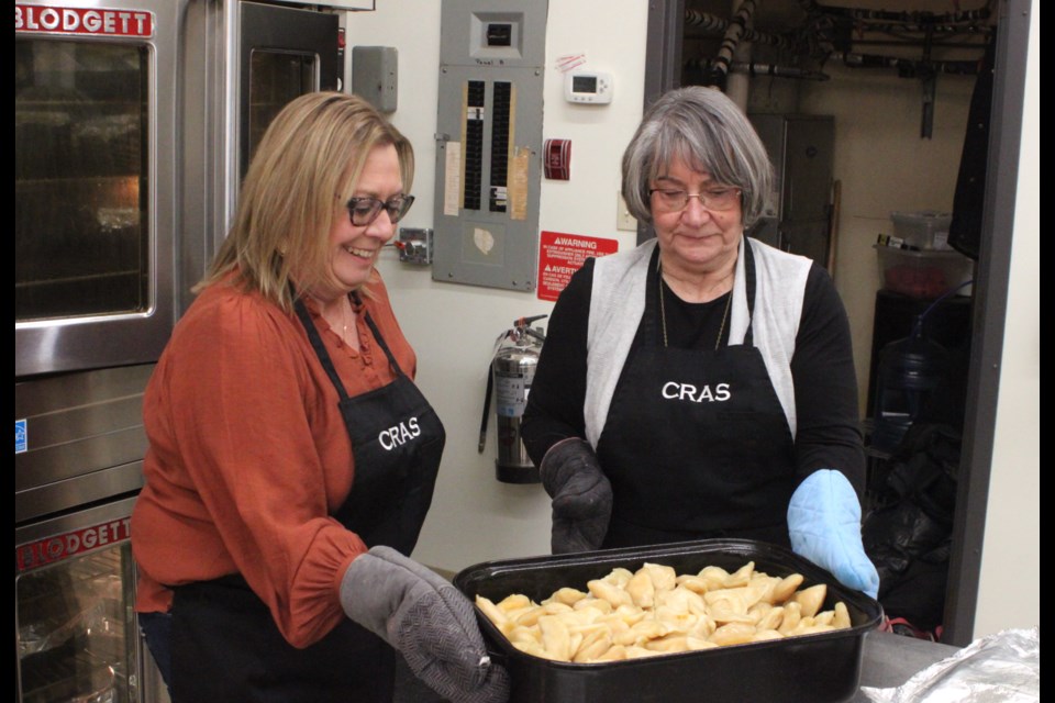 Gwen Beniuk and Angele Beniuk shake a pan of perogies to get them ready to be served at the annual Craigend Harvest Dinner and Dance, which took place at the Craigend Community Center on Saturday, Nov. 30. Chris McGarry photo. 