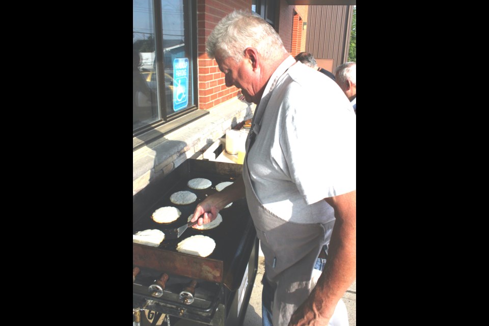 Henry Van Dorland, treasurer for the Lac La Biche Heritage Centre, put his culinary skills to work as he joined other volunteers cooking flapjacks for the pancake breakfast that kicked off Lac La Biche Summer Days Friday morning. Chris McGarry photo.