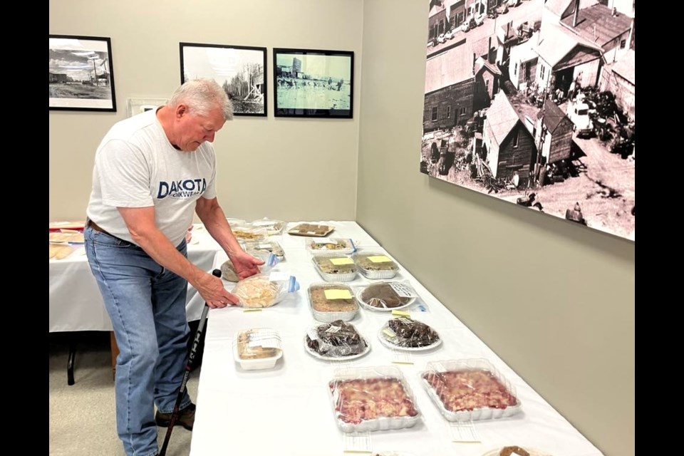 Henry Vandorland checks out the sweets on display for the bake auction. Chris McGarry photo. 