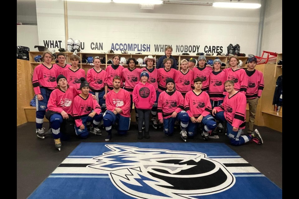 Colouring contest winner, Hailey, is pictured in the dressing room with the Junior B Ice team. / Photo supplied