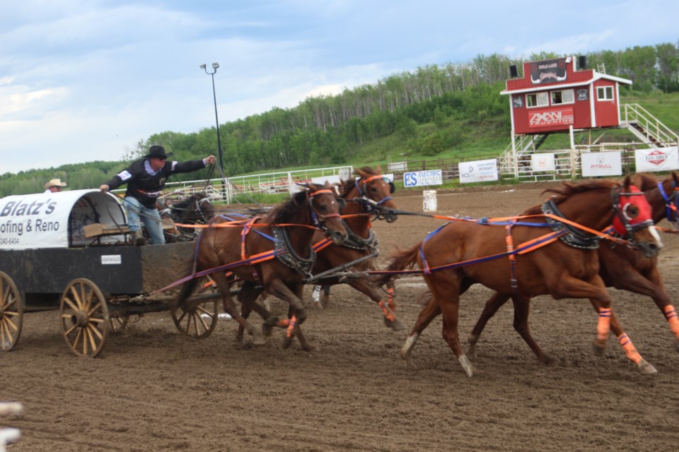 One of the teams in the competition at the AG society chuckwagon races encouraged their horses to go faster.