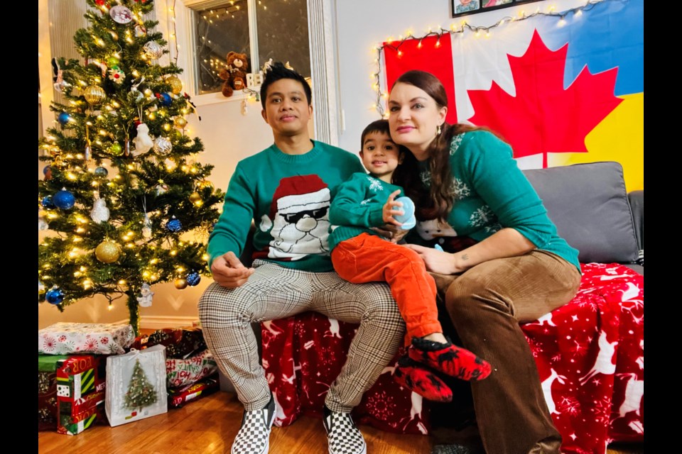 Joel Pascua (left) and Ganna Byelikova (right) are pictured with their son, William Pascua.