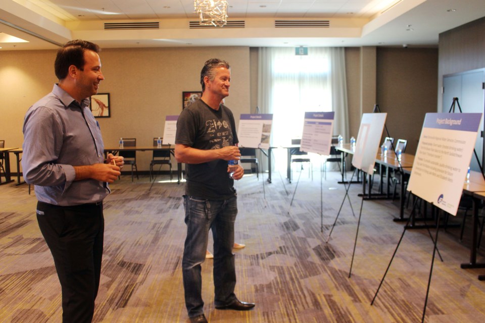 The Bonnyville Regional Water Services Commission hosted an open house on July 28 to discussed the proposed application for an inter-basin transfer of water to provide potable water to Frog Lake First Nations. Here, City of Cold Lake Mayor Craig Copeland speaks to Chad Maki, project manager with Associated Engineering. Photo by Robynne Henry. 