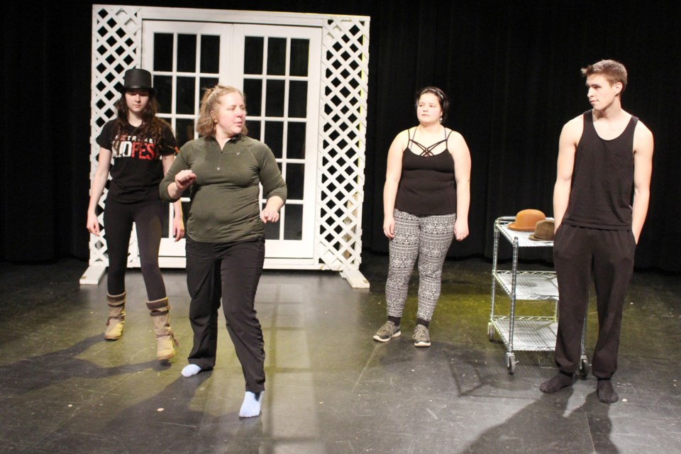 During their rehearsal at Cold Lake High School on Saturday, Feb. 1, assistant director Crystal Zaugg breaks down some choregrophy for Grade 12 students Jenelle Portes and Angel Oestreicher, and Grade 11 student Kody Duckett. Photo by Robynne Henry. 
