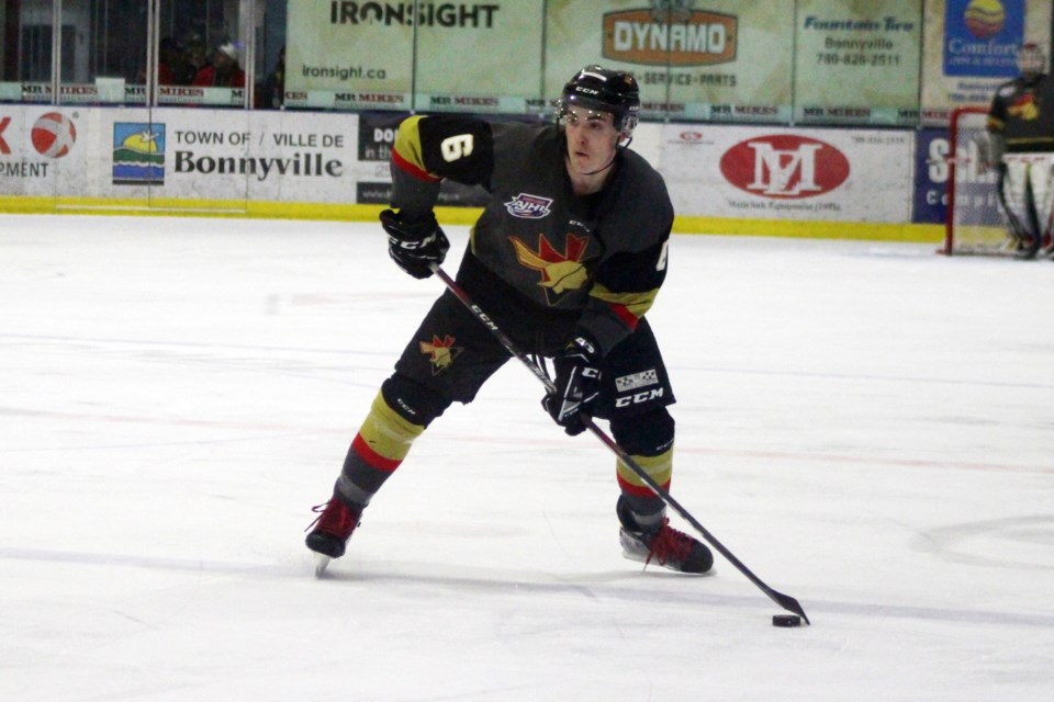 Pontiac Joshua Kroon looks for an open teammate during the Bonnyville Jr. A Pontiacs game against the Drumheller Dragons on Saturday, Feb. 1. Photo by Robynne Henry. 