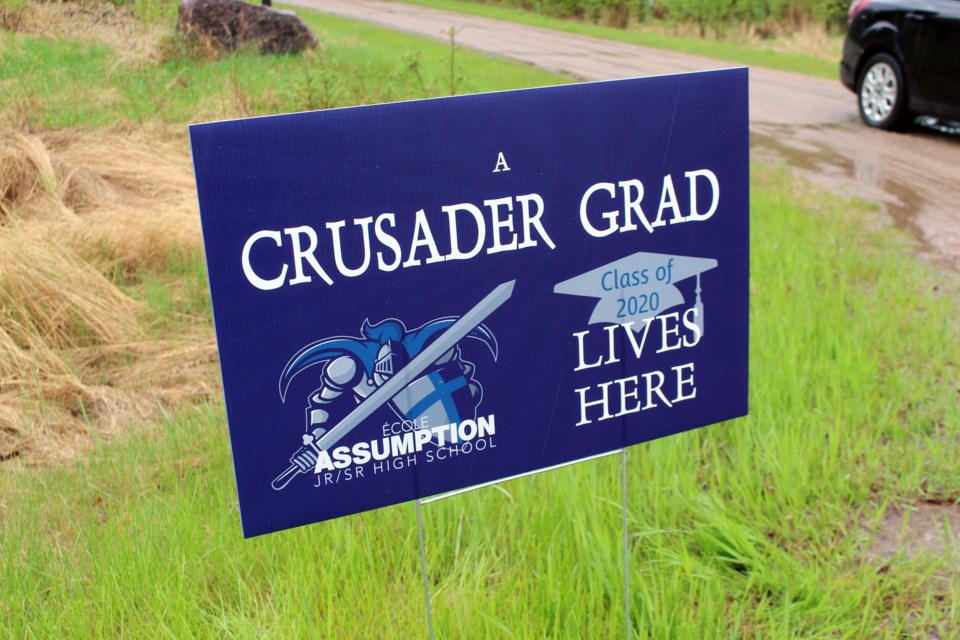 Staff and teachers from Assumption’s Jr./Sr. High School handed out signs to their 2020 graduating class on Thursday, June 4 as part of their Grad Rally. Photo by Robynne Henry. 