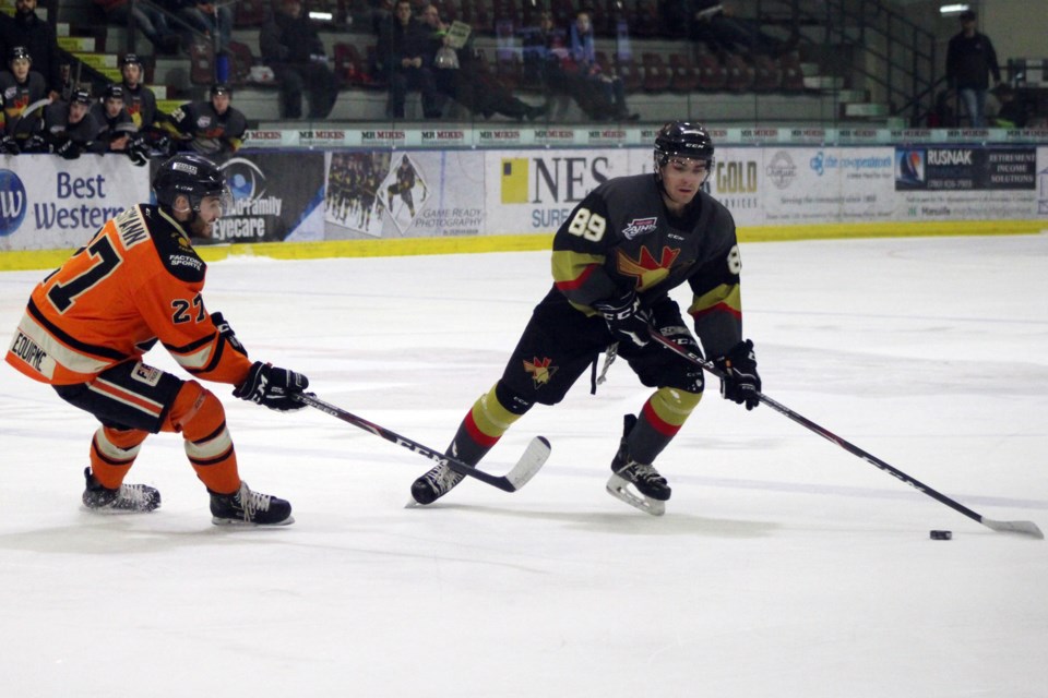 Bonnyville Jr. A Pontiac A.J. Macaulay keeps the puck away from the Lloydminster Bobcats during their game on Wednesday, Feb. 5. Photo by Robynne Henry. 