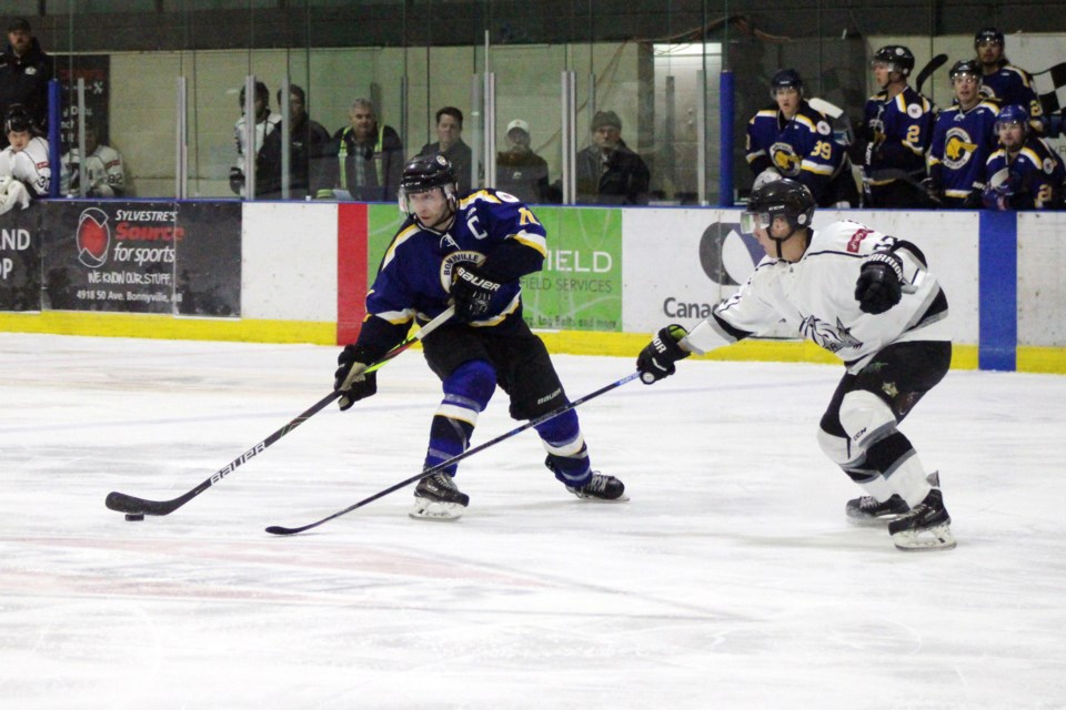 During the Bonnyville Sr. Pontiacs fourth game in their playoff series against the Morinville Kings, Lucas Isley keeps the puck away from the Kings' defensive line. Photo by Robynne Henry.