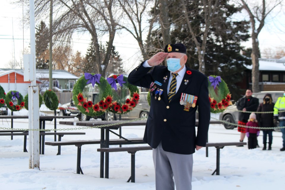 During the Bonnyville legion’s outdoor Remembrance Day Ceremony on Wednesday, Nov. 11, legion member and 35-year veteran Duane Hite salutes next to the wreaths. Photo by Robynne Henry.