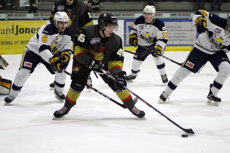 During the Bonnyville Jr. A Pontiacs game against the Spruce Grove Saints on Wednesday, Feb. 12, Matthew McKim keeps control of the puck. Photo by Robynne Henry. 