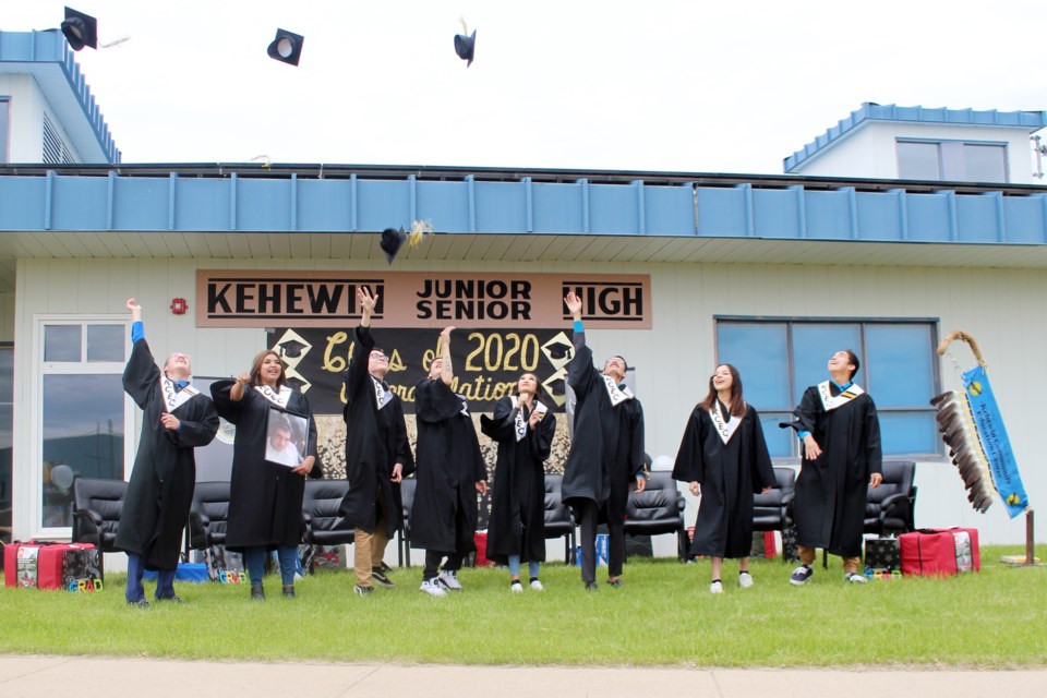 The graduating class from the Kehewin Community Education Centre throw their caps in the air during the June 19 ceremony. Photo by Robynne Henry.