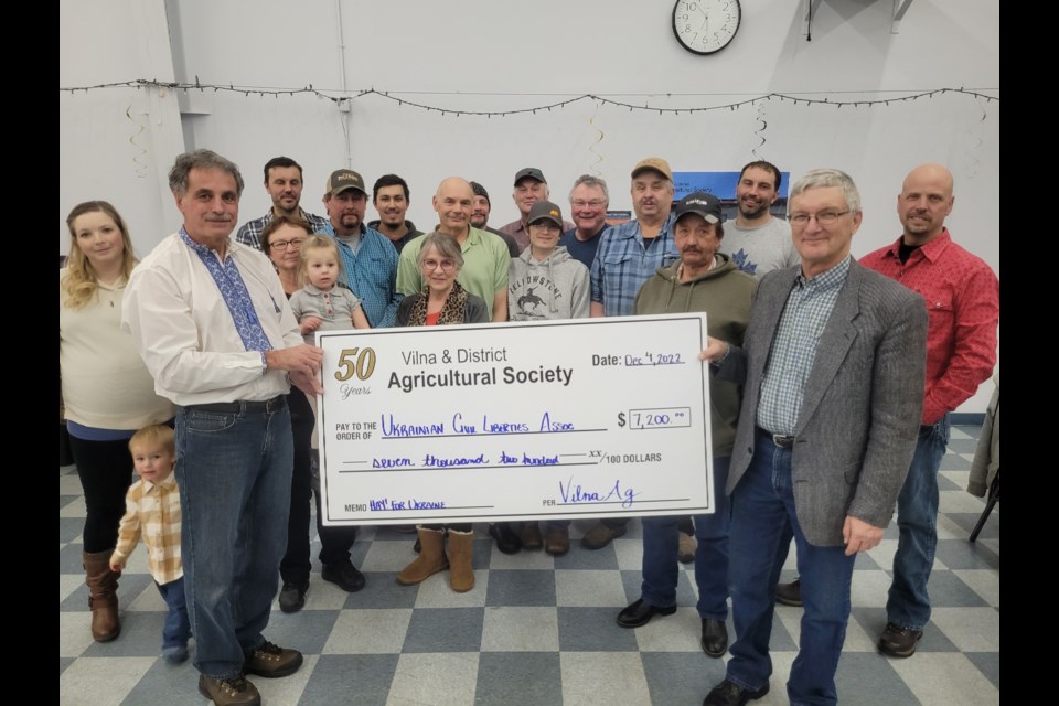 Amil Shapka (left) accepts a large cheque from the Vilna & District Ag Society during a community supper on Dec. 4. Funds are being donated to the Ukrainian Canadian Civil Liberties Association to help support humanitarian efforts in Ukraine.