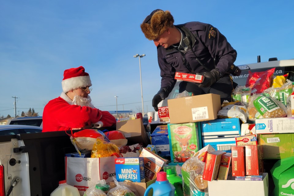 Bonnyville RCMP members had a helping hand from Santa during the Pack the Police Car event on Dec. 15.