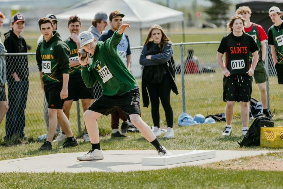 Two Hills School student-athlete Carsyn Milot throws a shot put during the SPAA track and field event on May 17. While he finished fourth in shot put, Milot also went on to set a new SPAA record in the junior boys' javelin event. 
