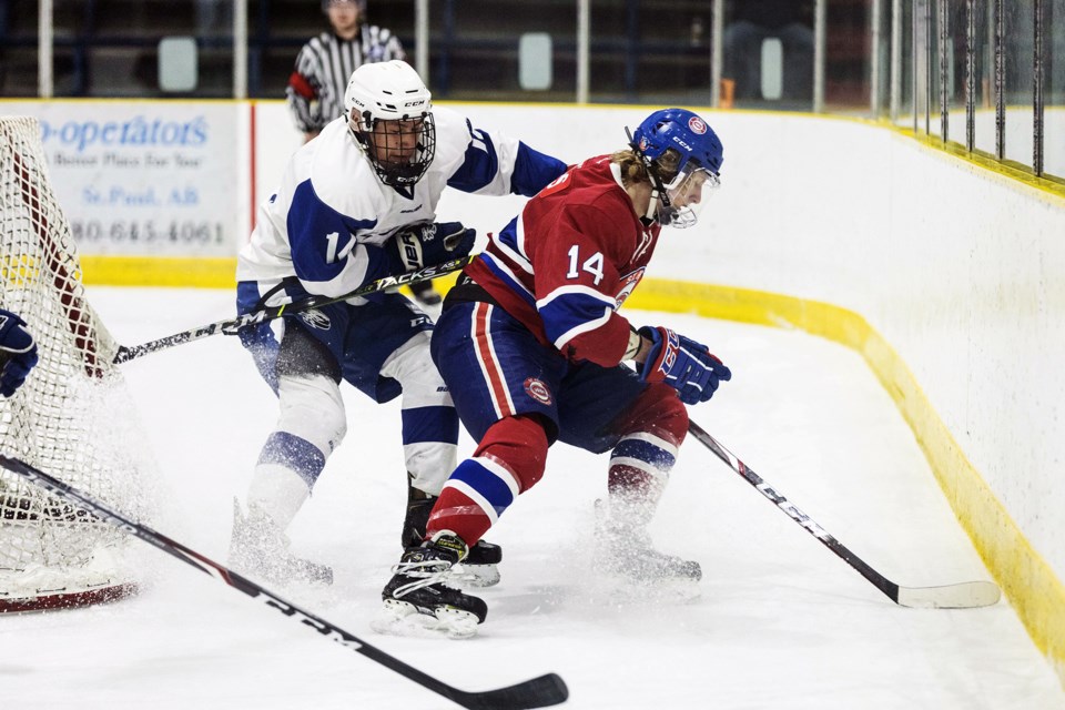 Isaak Watters fights for the puck on Friday night.