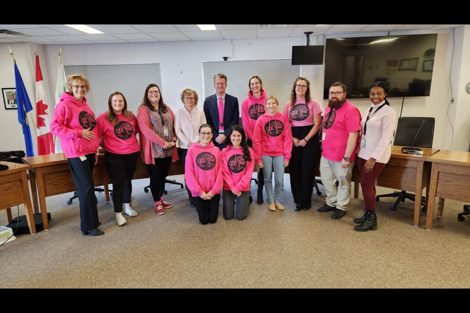 Mayor Craig Copeland (middle in pink tie) stands with City Hall staff on Pink Shirt Day.