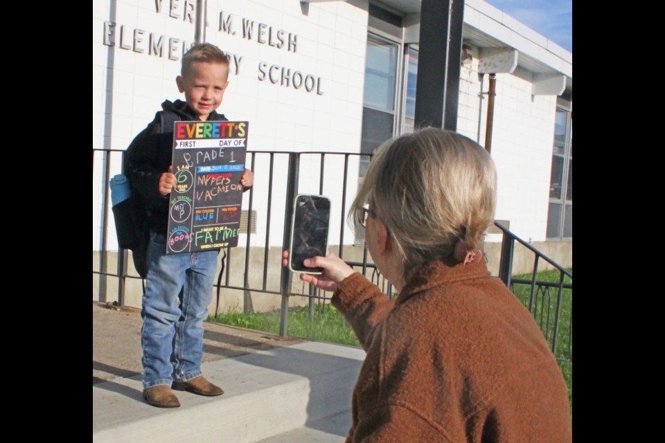 First-day photo: Amanda Cheyne takes a photo of her son Everett,6, as he goes into his first day of Grade 1 at Lac La Biche's Vera M. Welsh  Elementary School on September 5. From his hand-written sign, the youngster pictures himself using his education to become a farmer in the future.