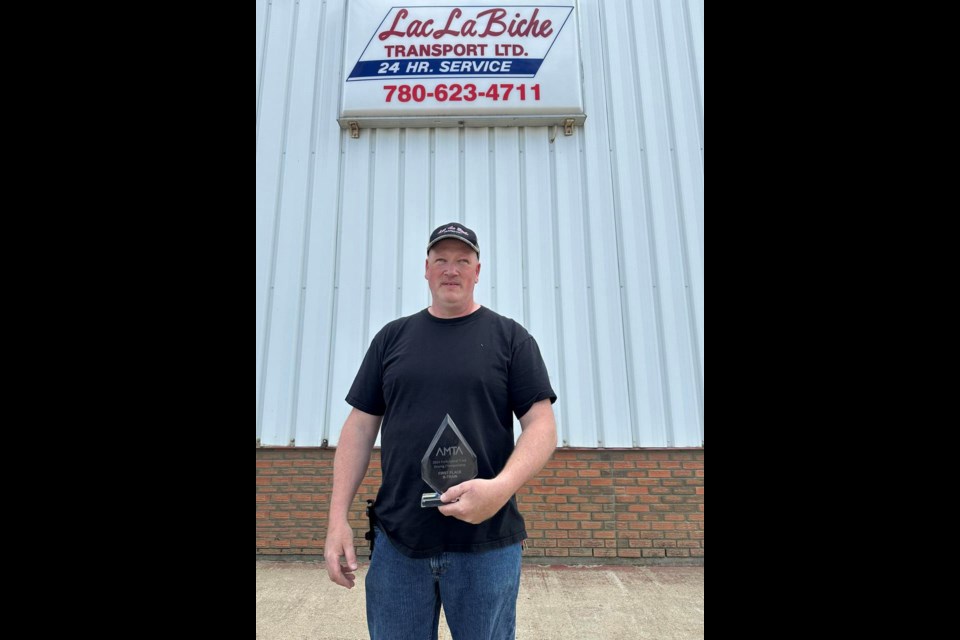Lac La Biche Transport's Tim Bingley with his award as the best B-train truck driver in the province after the recent Alberta Motor Transport Association Professional Truck Driving Championships.