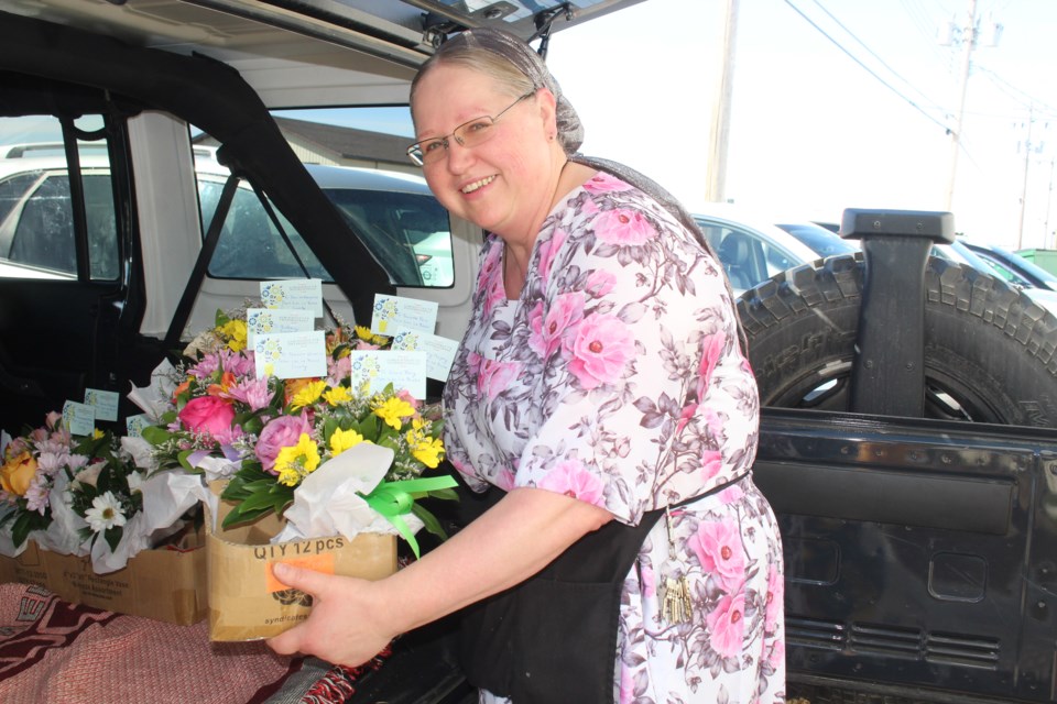 Anna Carroll from Reminiscence brings more bouquets to Wednesday's Lac La Biche POST delivery vehicle.