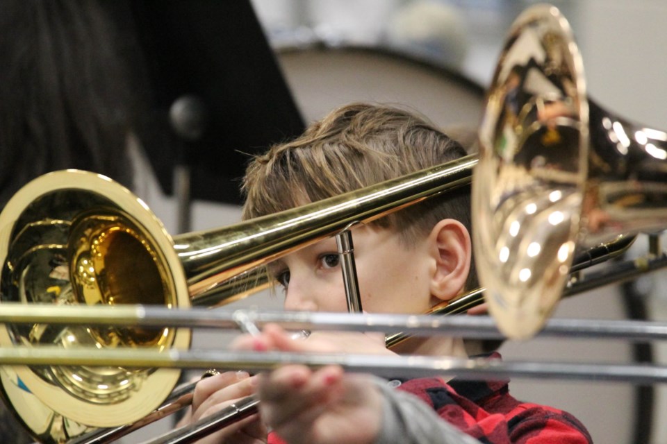 Class Brass Act — Aurora Grade 6 student Matteo Beniuk keeps an eye on his music sheets as he slides through a trombone section of a festive song with his band class during Friday afternoon's re-scheduled Aurora Middle School Christmas concert.