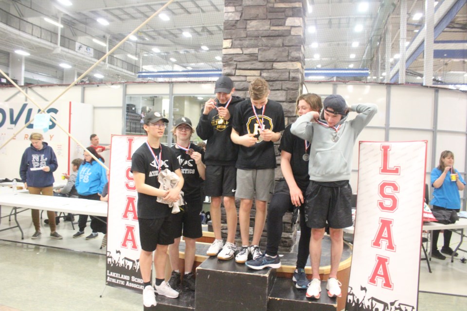 The top teams of the senior boys mixed event on the podium with the Cold Lake High School team of Gavin and Isaac checking out their gold medals.