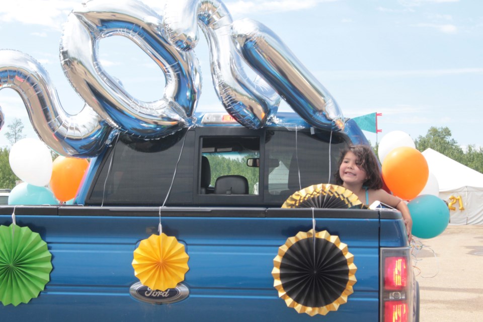 Amisk Community School Kindergarten graduate Quynn Brereton is all smiles as she takes the short ride to the ceremony in style.