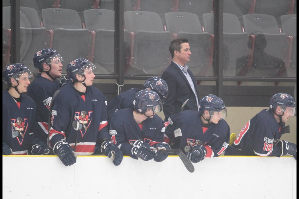 Portage College Athletics Director Nate Bedford (left) with assistant coach Kevin McLelland behind the Voyageurs bench during an early season game last year.    File / Rob McKinley