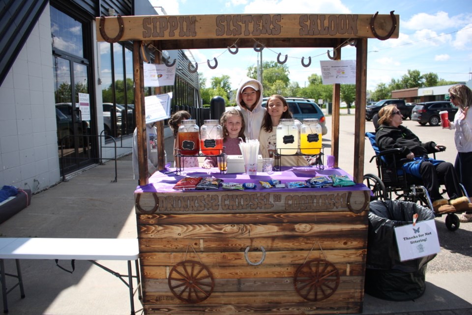 From the left Piper, Mya Baron, and Amy Baron tend the Sippin Sisters Saloon.