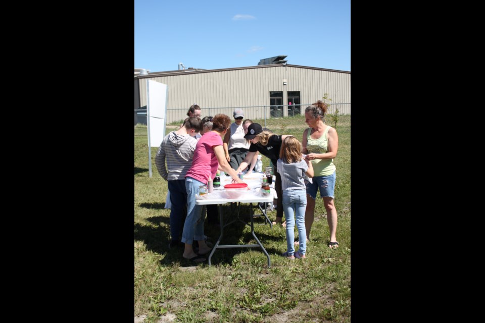 Attendees gathered at the community garden and learned to tie-dye cotton shirts with eco-friendly botanical dyes.