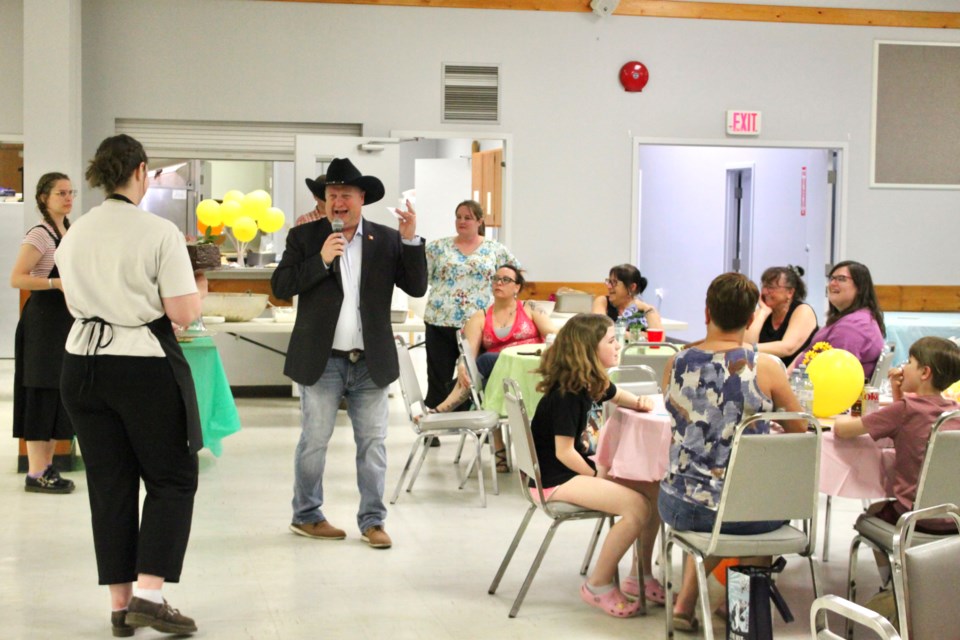 Shea Hatch, President of the Cherry Grove Ag Society, acted as an auctioneer during the Dessert Auction fundraiser.