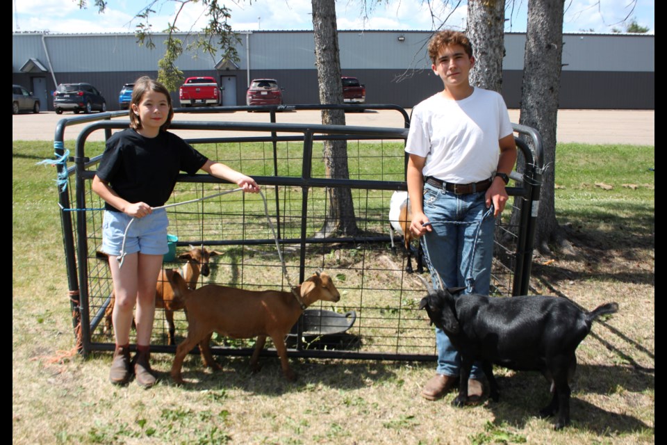Bonnyville 4-H members Charlotte and Eugene Lord brought their goats to the Glendon RCMP hall for the farm demo outside the Sunday farmers market.