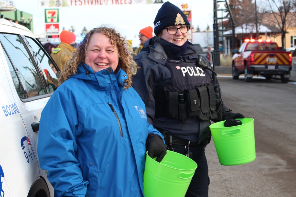 The Charity Check Stop took over main street on Saturday, Dec. 7. Here Bonnyville Victim Services Unit (VSU) assistant program manager Connie St. Pierre and Cst. Megan Letang collect cash donations. - Photo by Robynne Henry