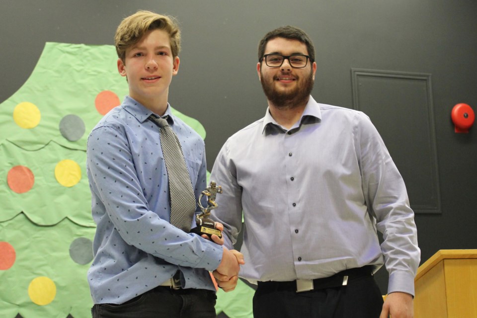 Cooper Prybysh accepts the defensive lineman of the year award from coach Taylor Klein. Photo by Robynne Henry