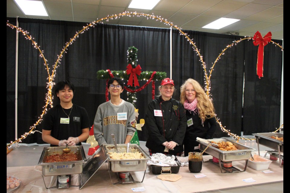 Volunteers served up international and Canadian fair at the Feast of Nations hosted by the Bonnyville Community Church. From the left: Justin Ocampo, Jacob Daugdaug, Lorranda Ledrew, and Marge Woods.