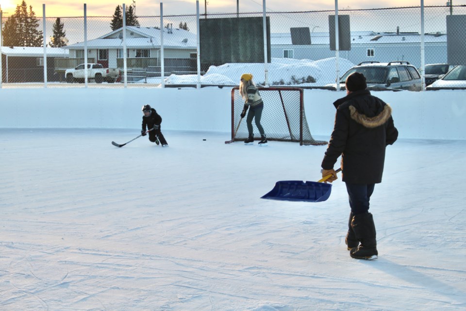 Leo Michaud brought his shovel to the Fort Kent outdoor skating rink for a skate with family, though wished for a snowblower. From the left: Zayne Eddamni, Natalie Kelly, and Leo Michaud.